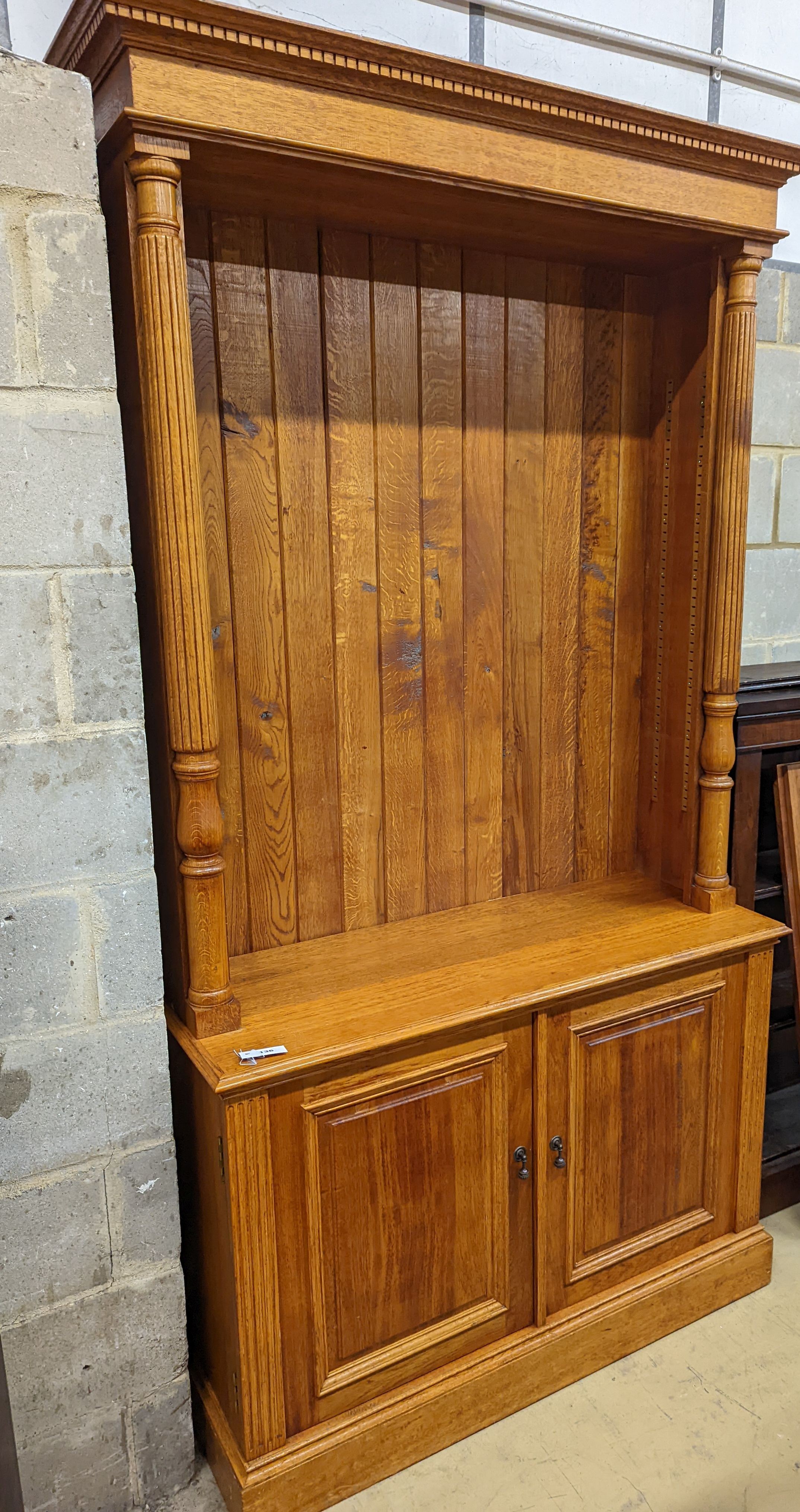 A Victorian style pale oak open bookcase, length 122cm, depth 46cm, height 229cm